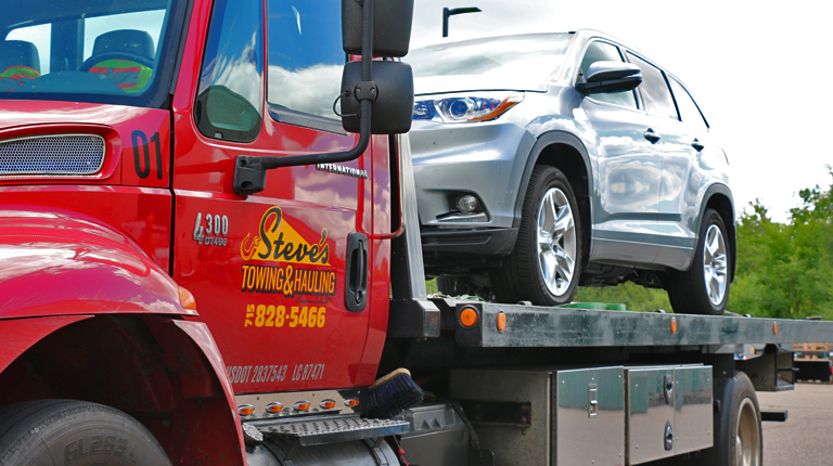 Image of tow truck with damaged vehicle